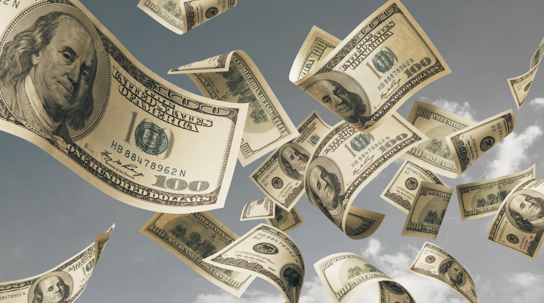 U.S. hundred dollar bills are shown floating and falling through the air against a cloudy sky background, hinting at the costly repairs often needed for garages plagued by termite problems.